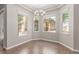 Dining area with tiled floors, chandelier, and abundant natural light from the windows at 224 Morgyn Ln # 6, Boulder City, NV 89005