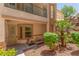 Attractive covered condo entrance with stone accents and mature landscaping at 224 Morgyn Ln # 6, Boulder City, NV 89005