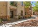 View of the side of the condo with a covered patio and well-maintained landscaping at 224 Morgyn Ln # 6, Boulder City, NV 89005