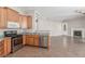 Open kitchen features wooden cabinets and stainless steel appliances, flowing into the living area at 224 Morgyn Ln # 6, Boulder City, NV 89005