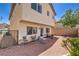 View of the house from the backyard showcasing gravel landscaping, brick border, and patio furniture at 261 Fairway Woods Dr, Las Vegas, NV 89148