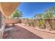 Cozy backyard with gravel, brick borders, small plants, and patio furniture at 261 Fairway Woods Dr, Las Vegas, NV 89148