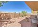 View of the backyard featuring gravel landscaping, brick border, small plants, and metal patio furniture at 261 Fairway Woods Dr, Las Vegas, NV 89148