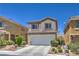 Charming two-story home with a two-car garage, green front yard, and inviting entrance at 261 Fairway Woods Dr, Las Vegas, NV 89148