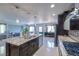 Elegant kitchen with granite island, stainless appliances, dark wood cabinets, and open floor plan at 261 Fairway Woods Dr, Las Vegas, NV 89148
