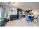 Modern kitchen featuring dark cabinets, stainless steel appliances, tile backsplash, and island seating at 261 Fairway Woods Dr, Las Vegas, NV 89148