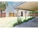 Backyard featuring a large covered patio area, lawn, and detached structure at 2616 Spear St, North Las Vegas, NV 89030