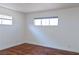 Bedroom with hardwood floors, light walls, and two windows providing ample natural light at 2616 Spear St, North Las Vegas, NV 89030