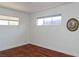 Cozy bedroom featuring hardwood floors, white walls, and natural light from two windows at 2616 Spear St, North Las Vegas, NV 89030