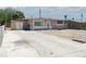Single-story home with long driveway, gravel front yard, and mature trees nearby at 2616 Spear St, North Las Vegas, NV 89030