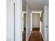 Narrow hallway featuring hardwood floors, white walls, closet and access to rooms at 2616 Spear St, North Las Vegas, NV 89030