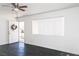 Bright living room with hardwood floors, a large window with blinds, and a front door at 2616 Spear St, North Las Vegas, NV 89030