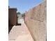 Side yard with gate and concrete brick walkway between wall and building at 2616 Spear St, North Las Vegas, NV 89030