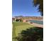 Serene backyard overlooking a lake, featuring a putting green, ideal for outdoor recreation at 2695 Olivia Heights Ave, Henderson, NV 89052