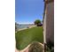 Lush backyard with well-maintained artificial turf and tranquil lake view, perfect for relaxing at 2695 Olivia Heights Ave, Henderson, NV 89052