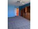 Spacious bedroom featuring a ceiling fan, blue walls, and built-in shelving at 2695 Olivia Heights Ave, Henderson, NV 89052