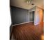Clean bedroom boasts wood floors and a mirrored closet at 2695 Olivia Heights Ave, Henderson, NV 89052