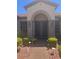 Close-up of a stylish front entrance showcasing a decorative security door and manicured landscaping at 2695 Olivia Heights Ave, Henderson, NV 89052