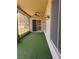 Enclosed patio showing artificial turf and a glimpse of the kitchen through a sliding glass door at 2695 Olivia Heights Ave, Henderson, NV 89052