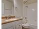 A bright bathroom features a vanity with granite counters, a toilet, and a shower-tub combo at 2785 Carnation Ln # 0, Henderson, NV 89074