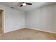 A well-lit bedroom with neutral carpet, light walls, and a ceiling fan provides a calm space at 2785 Carnation Ln # 0, Henderson, NV 89074