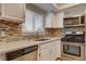 Well-lit kitchen with stainless steel appliances, light countertop, and stylish tile backsplash at 2785 Carnation Ln # 0, Henderson, NV 89074