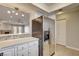 Kitchen showcasing stainless steel refrigerator and breakfast bar overlooking living space at 2785 Carnation Ln # 0, Henderson, NV 89074