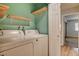 Dedicated laundry room with full-size washer and dryer hookups and shelving for extra storage at 2785 Carnation Ln # 0, Henderson, NV 89074