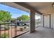 Private patio with metal railing overlooking greenery and parking offers a relaxed outdoor space at 2785 Carnation Ln # 0, Henderson, NV 89074