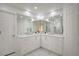 Bright bathroom featuring double sinks with white cabinets, gold hardware, and ample counter space at 2851 Queens Courtyard Dr, Las Vegas, NV 89109