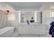 Modern bathroom with double vanity, marble accents, and a luxurious freestanding bathtub at 2851 Queens Courtyard Dr, Las Vegas, NV 89109