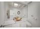 Modern powder room features unique gold vessel sink and an oversized mirror over marble countertop at 2851 Queens Courtyard Dr, Las Vegas, NV 89109