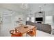 Elegant dining area with modern lighting adjacent to the open kitchen and living room at 2851 Queens Courtyard Dr, Las Vegas, NV 89109