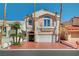 Charming two-story home with a well-manicured front yard and a two-car garage at 2851 Queens Courtyard Dr, Las Vegas, NV 89109