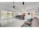 Bright living room with high ceilings, modern ceiling fans, and large sliding glass doors at 2851 Queens Courtyard Dr, Las Vegas, NV 89109