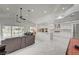 Open-concept living space with marble floors, modern fixtures, stainless steel appliances, and walls of windows at 2851 Queens Courtyard Dr, Las Vegas, NV 89109