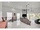 Bright living area featuring marble floors, a sleek gray sofa and golf course views from a wall of windows at 2851 Queens Courtyard Dr, Las Vegas, NV 89109