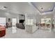Open-concept living space with marble floors, modern fixtures, stainless steel appliances, and walls of windows at 2851 Queens Courtyard Dr, Las Vegas, NV 89109