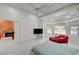Large main bedroom with marble floors, a ceiling fan, and a cozy red chair with window views at 2851 Queens Courtyard Dr, Las Vegas, NV 89109
