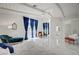 Expansive main bedroom featuring marble floors, a ceiling fan, and elegant blue curtains at 2851 Queens Courtyard Dr, Las Vegas, NV 89109