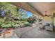 Covered patio with outdoor seating overlooks a lush, green golf course surrounded by mature trees at 2851 Queens Courtyard Dr, Las Vegas, NV 89109