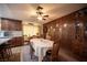 Inviting dining area with wood-paneled accent wall, seamlessly connecting to the kitchen and living room at 3484 Anthony Dr, Las Vegas, NV 89121