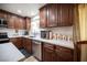 Updated kitchen featuring dark wood cabinets, white countertops, stainless steel appliances and modern fixtures at 3484 Anthony Dr, Las Vegas, NV 89121