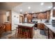 Charming kitchen boasts recessed lighting, dark wood cabinetry, stainless appliances, and breakfast bar seating at 3484 Anthony Dr, Las Vegas, NV 89121