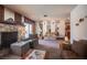 A second view of the carpeted living room with a rock fireplace at 3484 Anthony Dr, Las Vegas, NV 89121