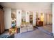 Carpeted living room features ample natural light and mirrored wall at 3484 Anthony Dr, Las Vegas, NV 89121