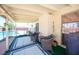Relaxing covered patio featuring comfortable wicker chairs and views of the fenced pool area at 3484 Anthony Dr, Las Vegas, NV 89121