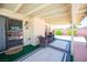 Covered patio with comfortable seating and a view of the pool and landscaped backyard at 3484 Anthony Dr, Las Vegas, NV 89121