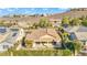 Aerial shot of a home featuring a covered patio and landscaped backyard, surrounded by lush greenery and fencing at 37 Stonemark Dr, Henderson, NV 89052
