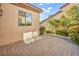 Quaint back patio featuring brick pavers, offering a private and inviting outdoor space, with desert landscaping views at 37 Stonemark Dr, Henderson, NV 89052